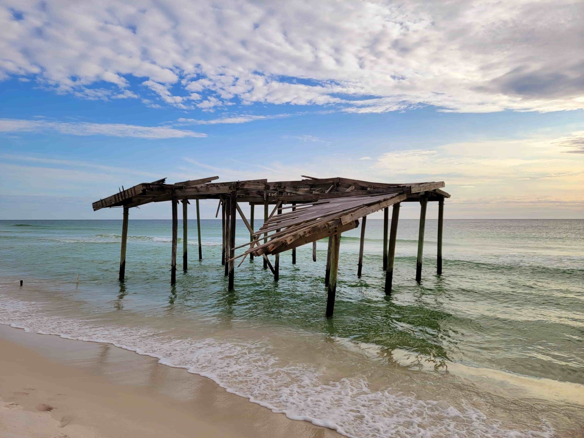 Rustic wooden structure sitting along the shore of a beach.